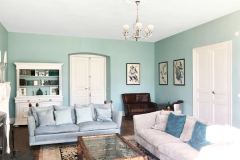 The grand salon offers seating for all and doors open to outdoor terraces