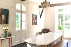 The dining room has both large and small tables and doors to an outdoor terrace